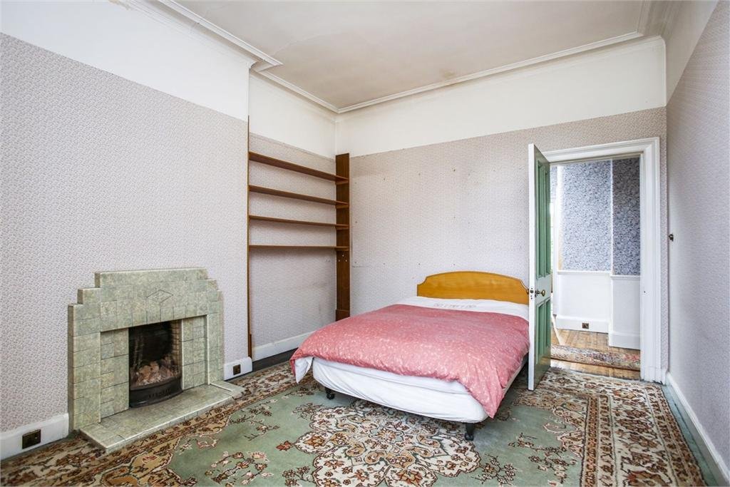 Definitely a bedroom here - note the much simpler cornincing. Same story with the fireplaces. No that's not a fitted carpet, it's a giant rug that's been hacked to fit the floor.