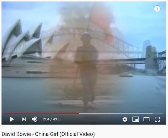 11) Those swirls are definitely a  #redflag! Speaking of which, the eponymous  #ChinaGirl is then seen carrying one across the desert while wearing uniform. (Video was shot in Oz, BTW.) Later in clip a similar image appears in montage of  #SydneyHarbour.