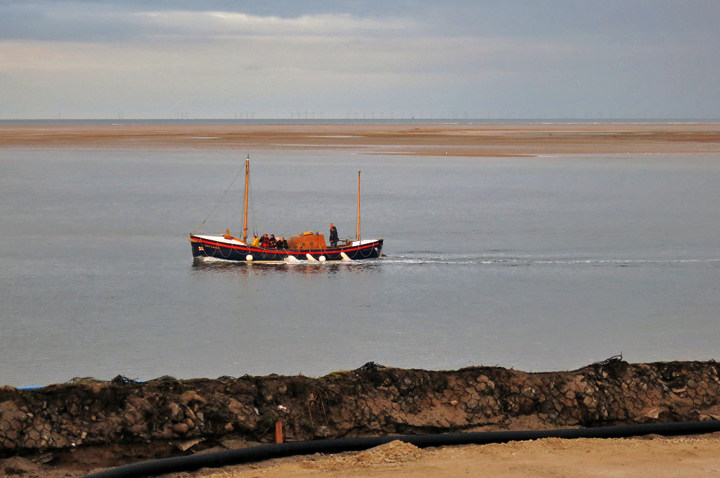 Cleared view north over the sea defence where the new Wells lifeboat station ramp will be; restored 80 year old Liverpool class lifeboat 'Lucy Lavers' which served here for a few months 57 years ago passing by #wellsnextthesea 1/10