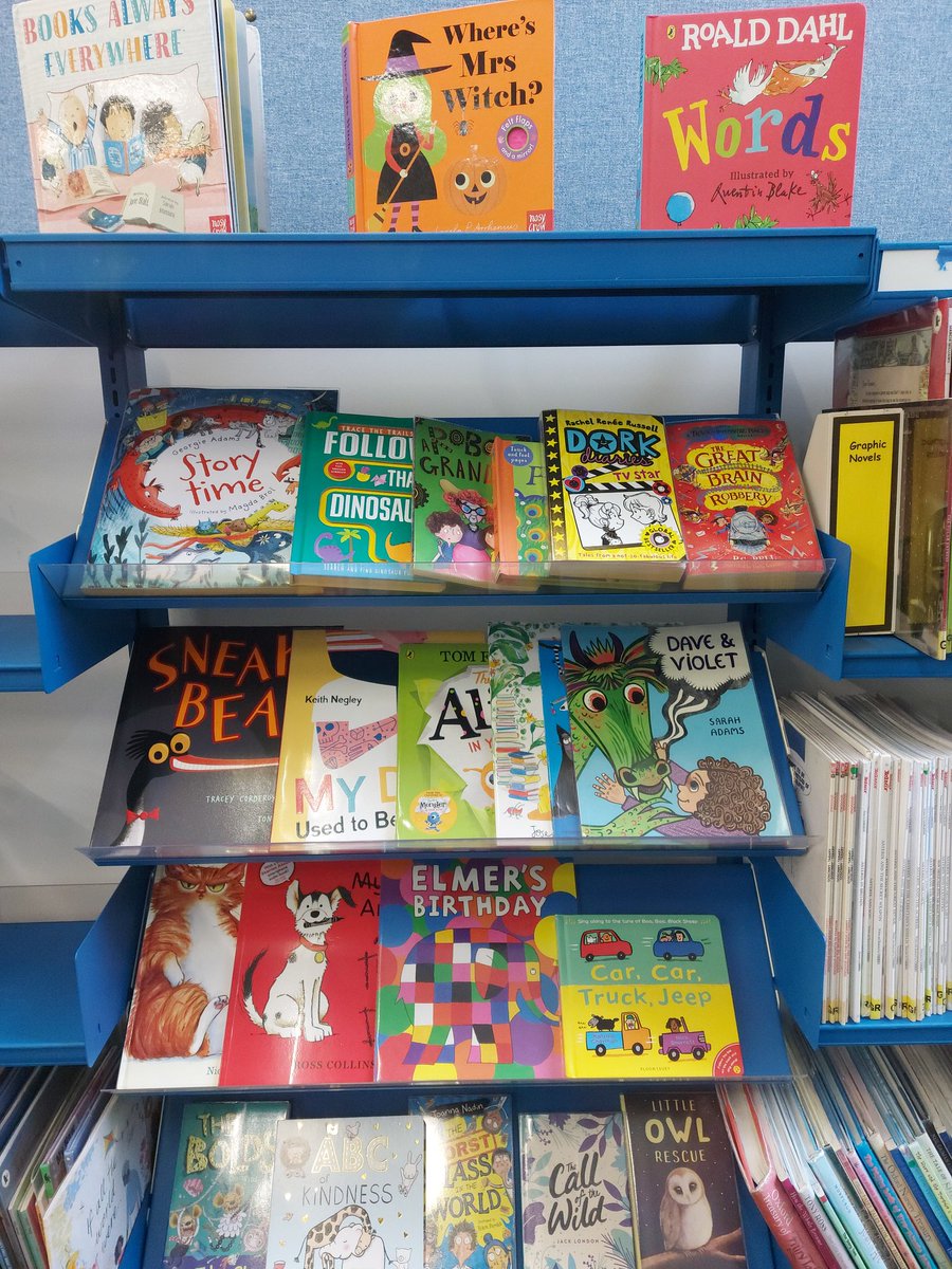 Late as always! I'm Helen Harvey, my MG book #EmmyLevelsUp comes out next year. I'm at work in the library today, so here are our new book shelfies #MGBooktober