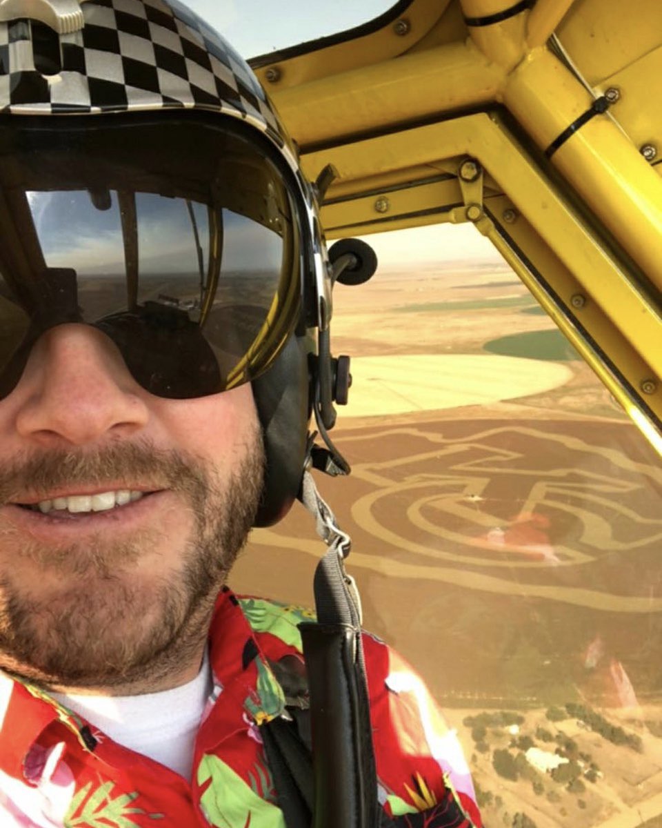 Spray pilot checking out my <a href="/Chiefs/">Kansas City Chiefs</a> field art.  He sprays comfortably