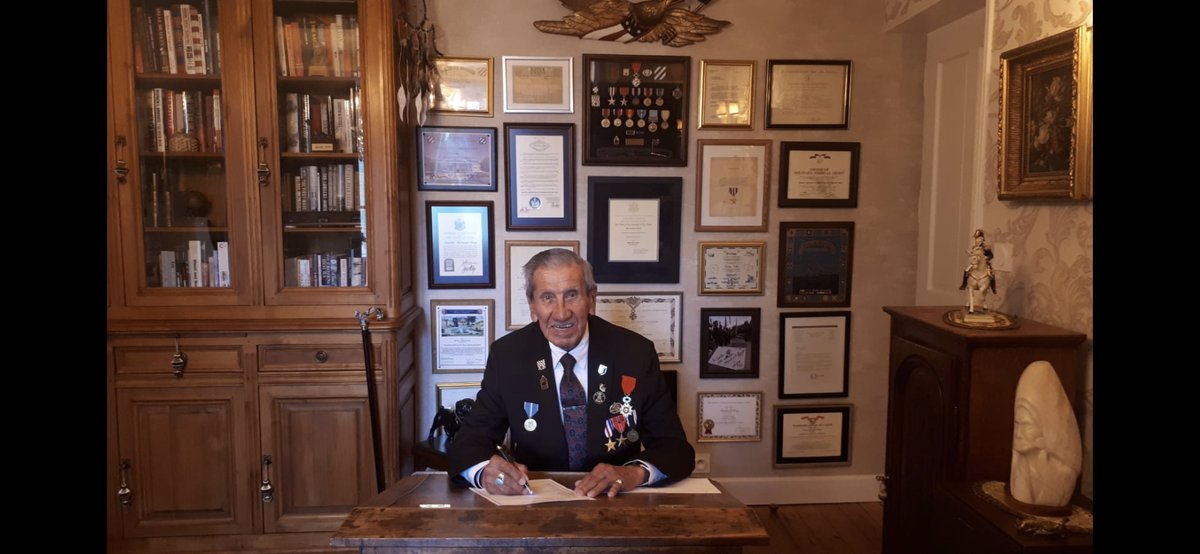 kershaw_alex's tweet photo. Charles Shay this week in Normandy, where he landed on D Day as a medic, signing his postal ballot, aged 96. #VOTE #WWII #firstwavebook #NativeAmerican https://t.co/KLabIXL669