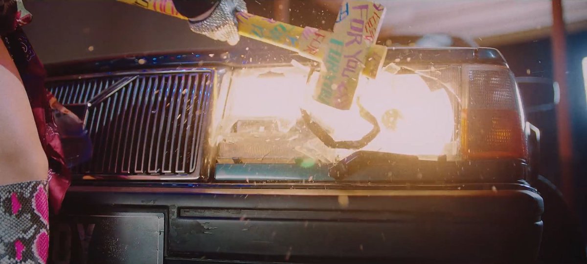 "FOR YOU" was written on the hammer. She smashed the car with it that may represent her past love, just like on jennie's scene.