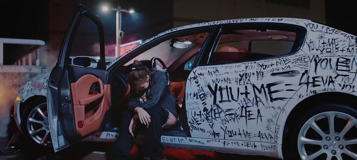 "FOR YOU" was written on the hammer. She smashed the car with it that may represent her past love, just like on jennie's scene.
