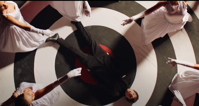 Of course, we have L laying on a literal target as the hetero couples dance around him, looking lost and alone, constantly waiting. Feeling targeted by this world of pretense and heterosexuality, feeling like he's living a lie. This is a coming out song in a lot of ways.