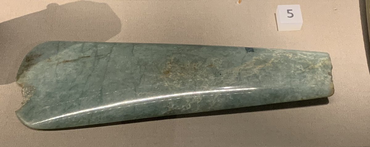 A jadeite axe (4000 BC-ish): fashioned in the Alps, brought to Wiltshire via Brittany, & then deposited in the River Avon.Found in 2003. The discoverer tried to use it to open a letter, couldn’t, & angrily threw it out of a window - hence the chip...  #WiltshireMuseum.