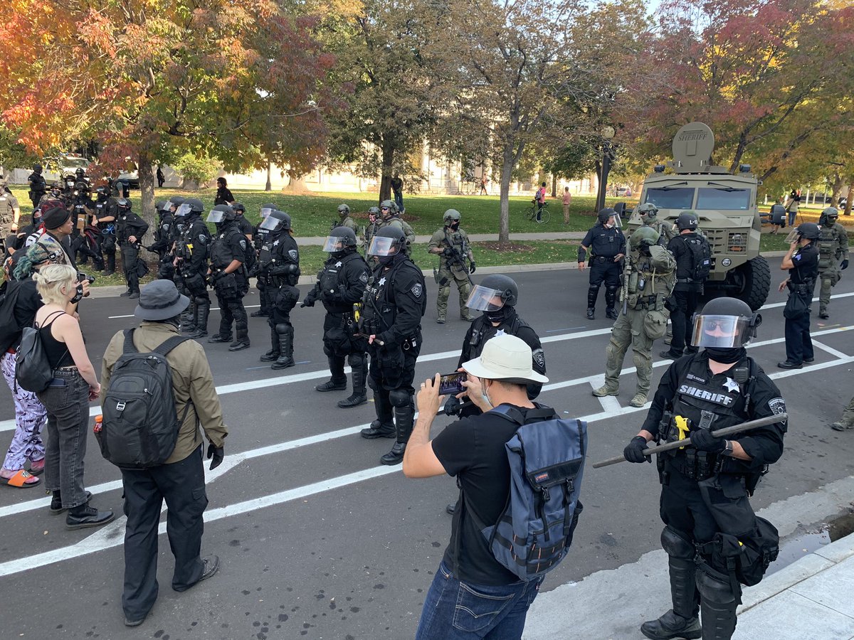 There are a lot of police officers out today separating the two groups. There are also fences all around civic center park keeping the two groups apart. The far-left group here right now is shouting “the only good cop is a dead cop”  #9News