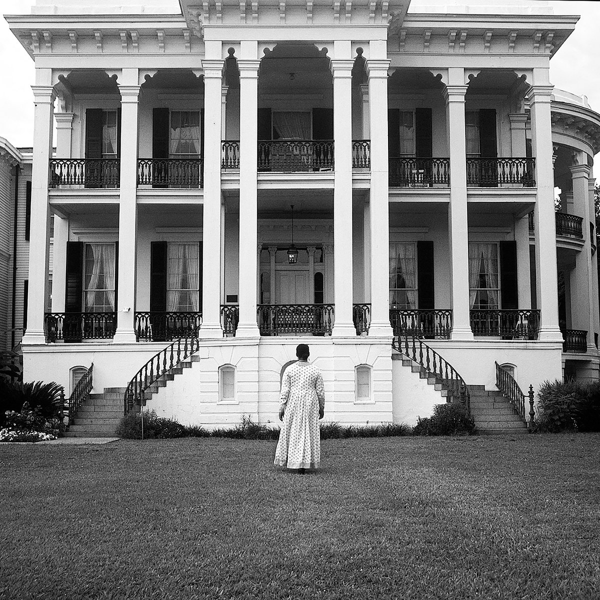"In her 2003 Louisiana Project, photographer <a href="/WEEMSCarrie/">Carrie Mae Weems</a> places her body in front of antebellum houses and spaces, reminding the viewer that enslaved people once occupied these spaces. These are photos of property that foreground a woman who would have been property."