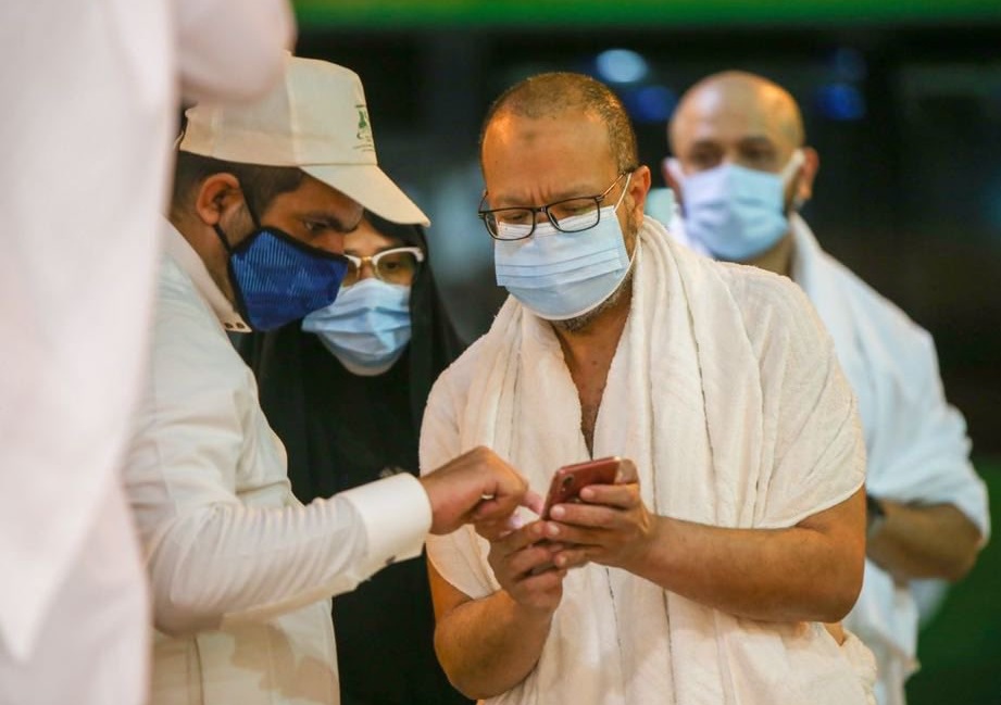 Saudi_Gazette's tweet photo. #PICTURES: Grand Mosque starts receiving first groups of Umrah performers, with application of precautionary measures to prevent the spread of #coronavirus. https://t.co/PLZKdsRn2J