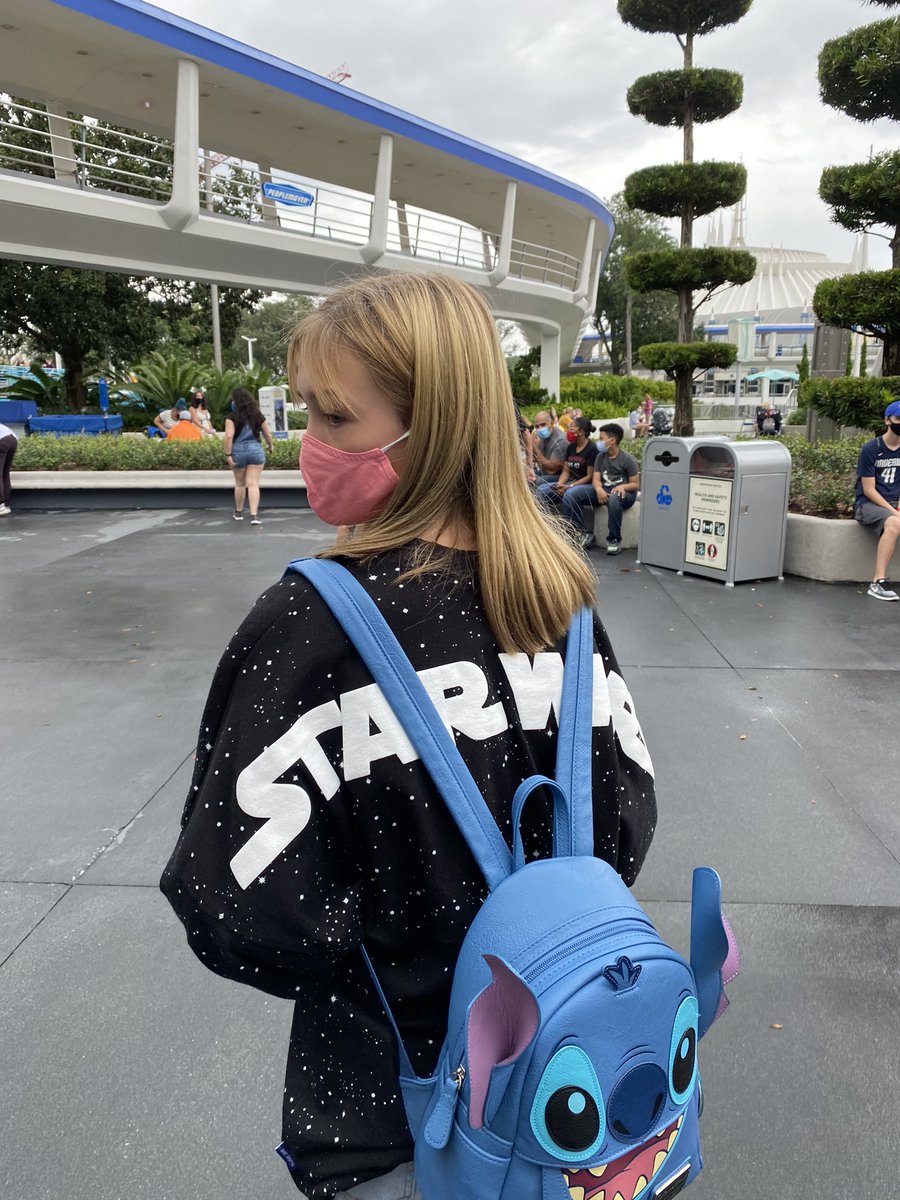 look how cute her shirt is  tomorrowland is the best bet for sw merch in magic kingdom