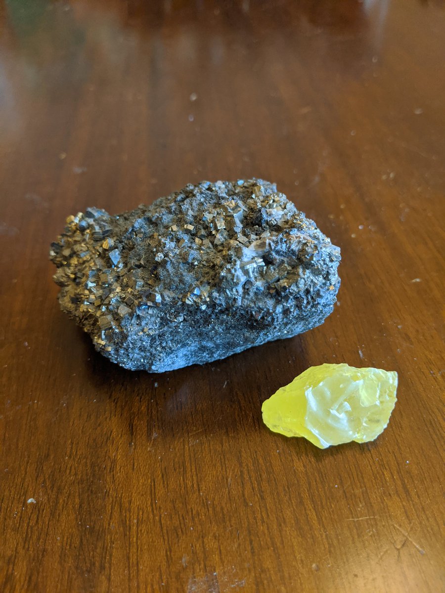 One of Ellen's favorite minerals is pyrite AKA fool's gold! Pyrite is an iron sulfide with the chemical formula FeS₂. Swipe to see a picture of pyrite next to a pure sulfur mineral. #sedmydearpod #minerals #pyrite #sulfur