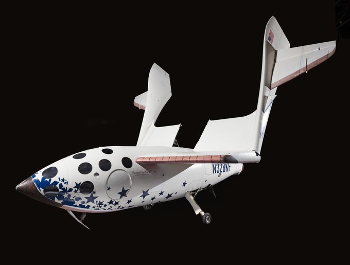 White spacecraft with blue stars and red accents on it.