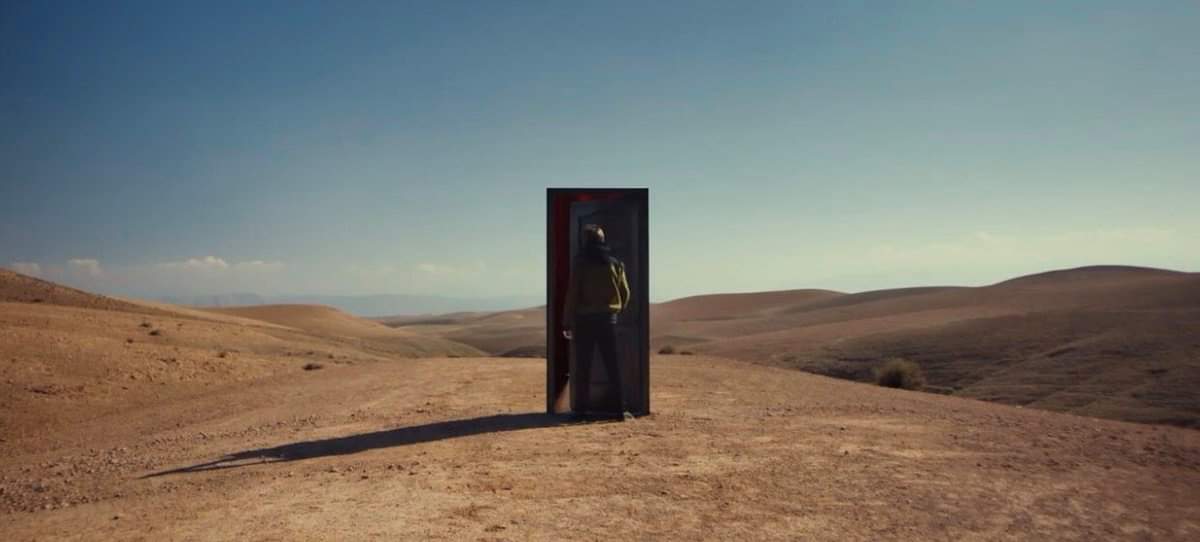 For the MV of walls, we see at the beginning that it's in a desert place and Louis is walking alone. And we will see a door with no walls and without hesitation he will open the door.