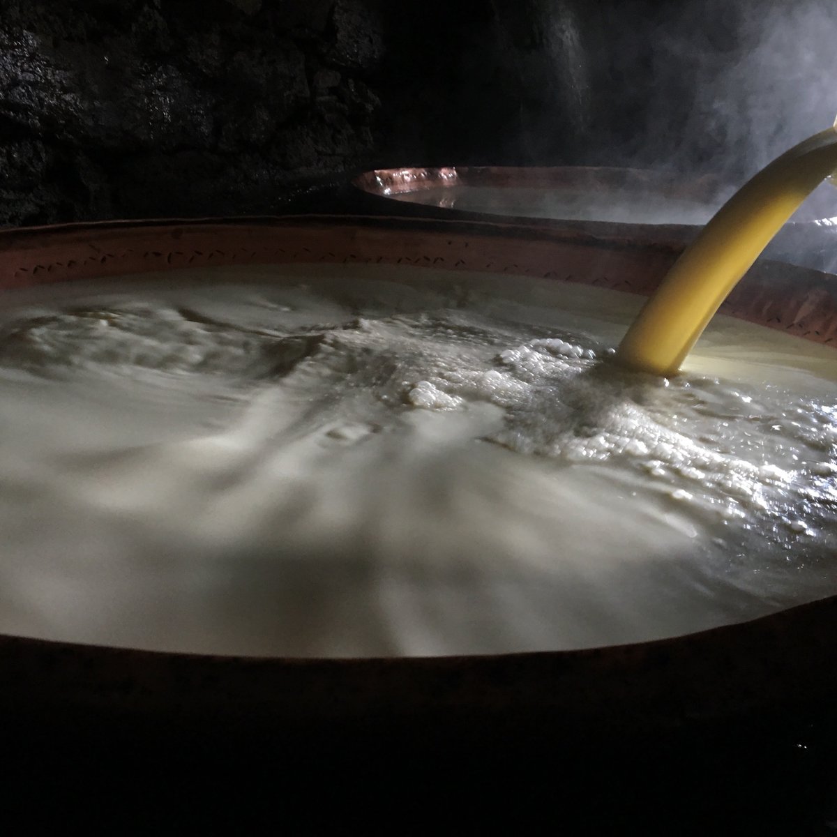 I'd like to share what I've learned while staying with my friend about the process of making butter. Immediately after milking the milk is poured into large hammered copper bowls that rest in a channel of flowing water which flows around them keeping them cool.