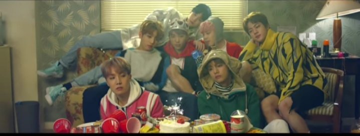 In the next scene, the members didn't look happy although there were cakes, candles and fireworks. It seemed that they longed for something. There's only a single candle on the cake symbolising that 1 years has already passed since the incident took place.