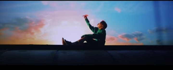 In the next scene we see Hoseok, relieved and happy. He flies and plane and put his arms up un the air depicting freedom.