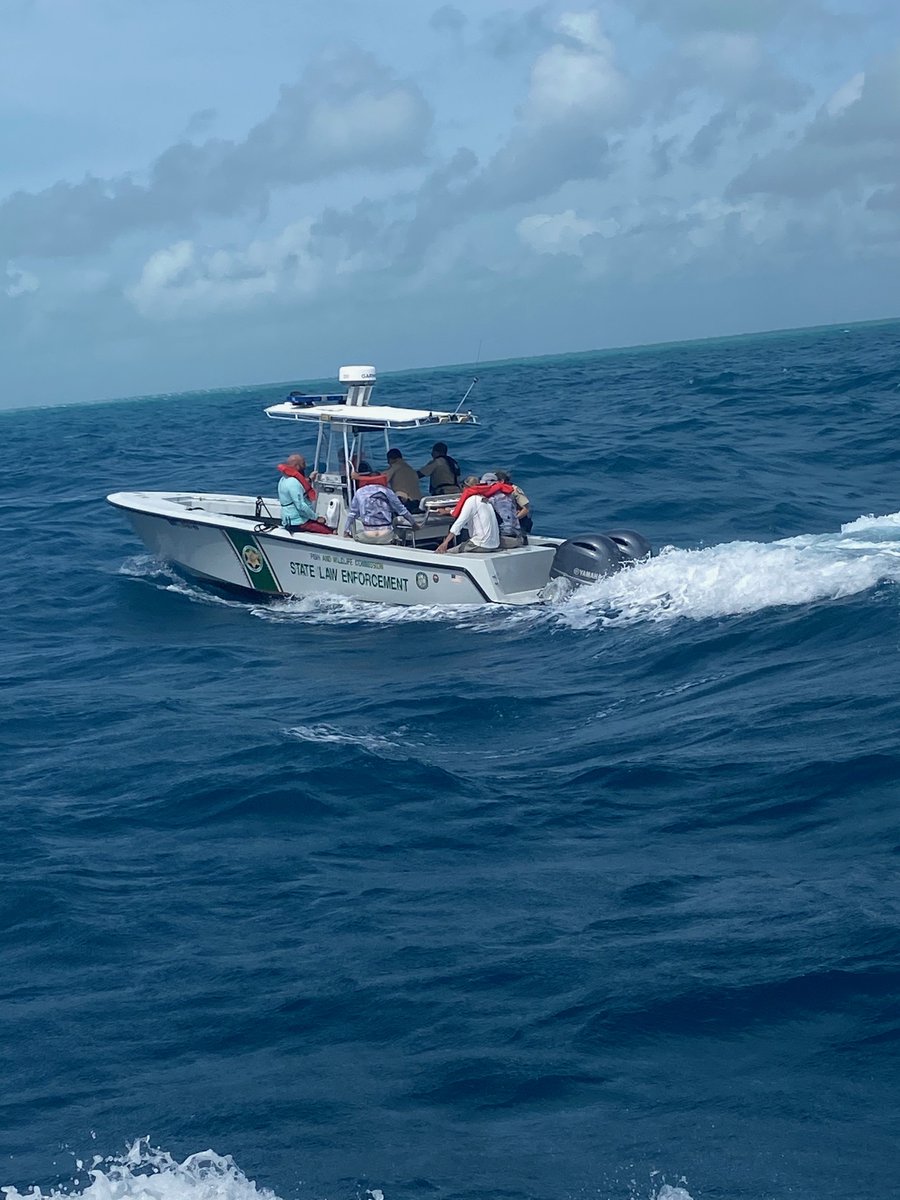 A FWC boat with 5 rescued people aboard after their boat sank off molasses reef, key largo.