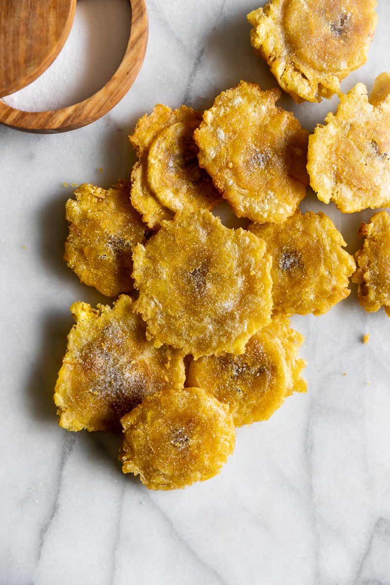 Now if you take the plátano when the skin is still super green, and you chop it up, fry it, then smash it, then fry it again, you got yourself TOSTONES!
