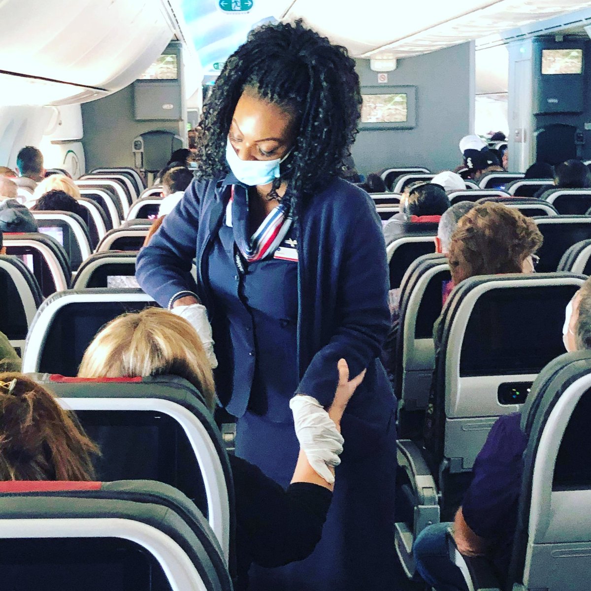 ToshiraS's tweet photo. @CNN @AmericanAir On my last flight from ORD to DFW my entire crew.. all 8 of us... were being furloughed and out of everyone a passenger stopped me and said she felt she needed to pray for me. I teared up and another flight attendant captured the moment without me knowing.  🙏🏾✈ https://t.co/C4Ml9KU8oM