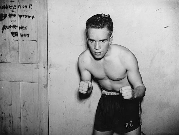 The Art of Album Covers .Empire Games bronze winning Scottish flyweight boxer, Hugh Cameron, October 1938.Photo by David Savill.Used by The Pogues on Peace and Love, released 1989.The fifth finger was added by sleeve designer, Simon Ryan, to accommodate the word "PEACE".