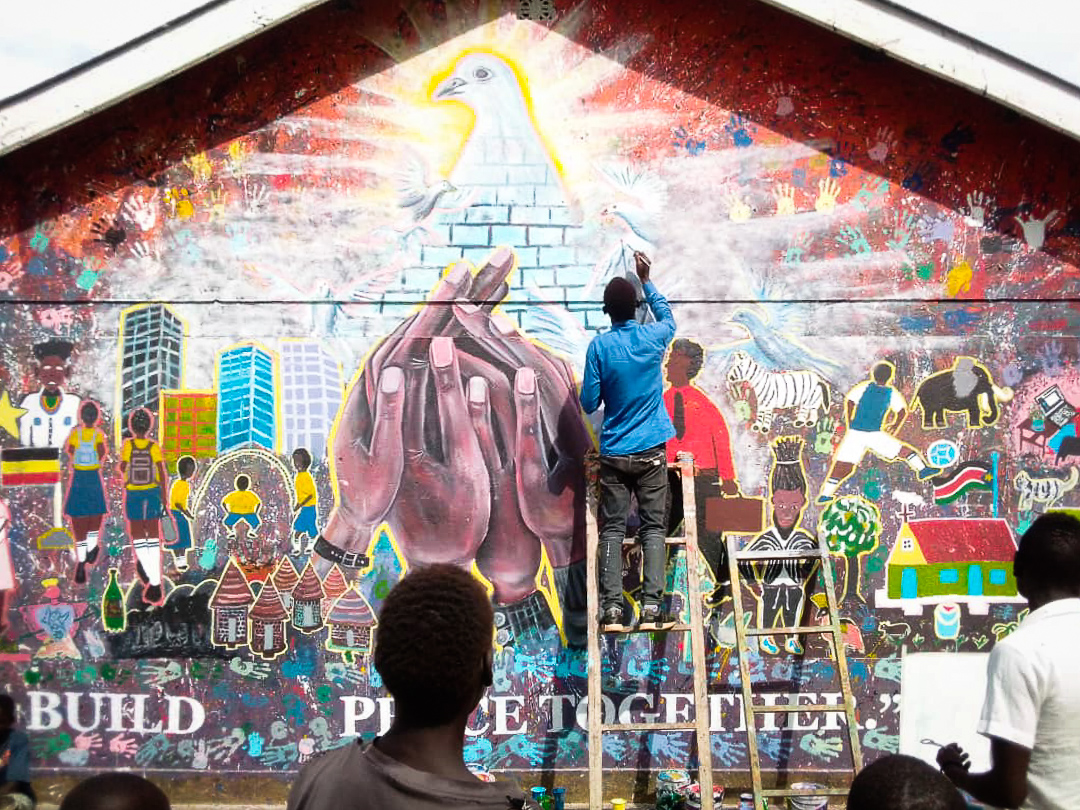 ArtolutionOrg's tweet photo. In honor of World Peace Day on September 21, our local Artolution team in Uganda created this incredible mural with refugee youth and children on building peace together. #callforpeace In partnership with @UNHCRuganda -- #jointheartolution https://t.co/XxYwKX05ES