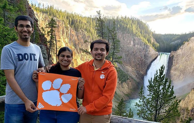 Photo of three Clemson fans holding a Tiger Rag at Yellowstone National Park.