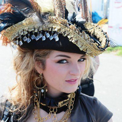 While Perdita can get really wild with the way she decorates the tricorn hat (as illustrated in the images below,) most of the time, she keeps things simple: neat trim, cockade and/or brooch, one prominent feather, maybe some chain.