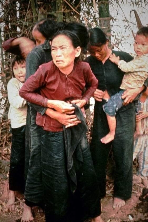 A Vietnamese teenager buttons up her mother's blouse after she was sexually sexually assaulted by American soldiers. They were killed moments after this photo was taken on the 16th of March 1968 as part of the My Lai massacare