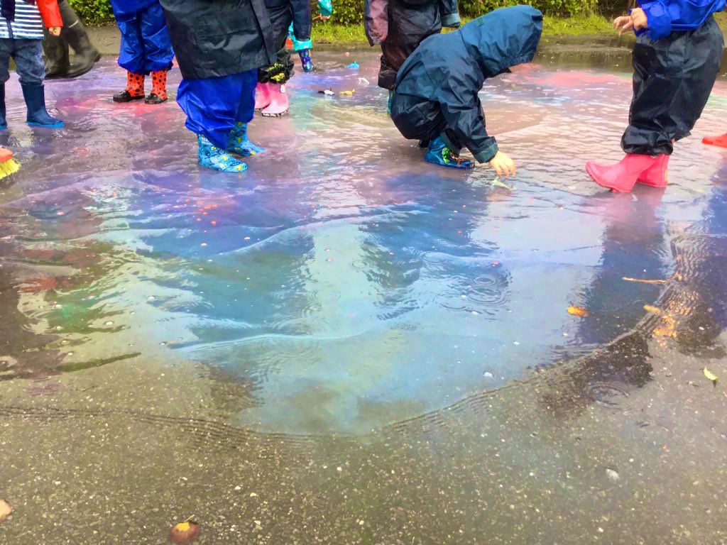 What happens when it’s raining outside??? Put on our wet suits and wellies, take powder paint to the puddles and mix colours to make magic puddles #eyfs #outdoorplay #rain #wellies #wetsuits