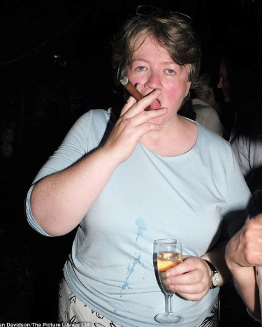 Danny Wallace on Twitter: "@mrjd1984 It is Therese Coffey. She stares to  camera, as if to say "YES IT'S ME", while her tongue prods at a cigar. She  holds a glass of