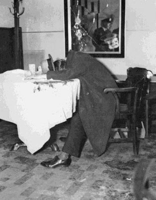Famous picture of Dutch Schultz at the table in the fedora.