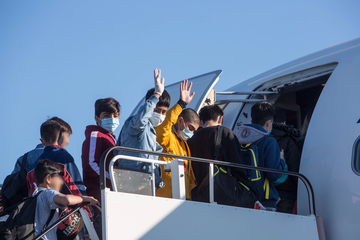 Photo of children boarding a plane