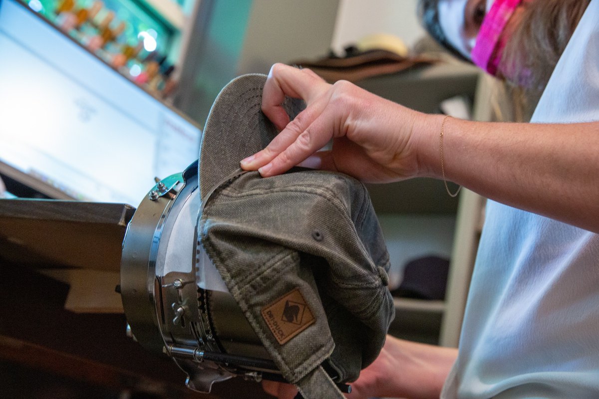 50lougift's tweet photo. The machines can't do everything, Tobie's prepping a hat for our embroidery machine to get those stitched just right. #SmallBatchPrinting https://t.co/8D7eKpjlzD