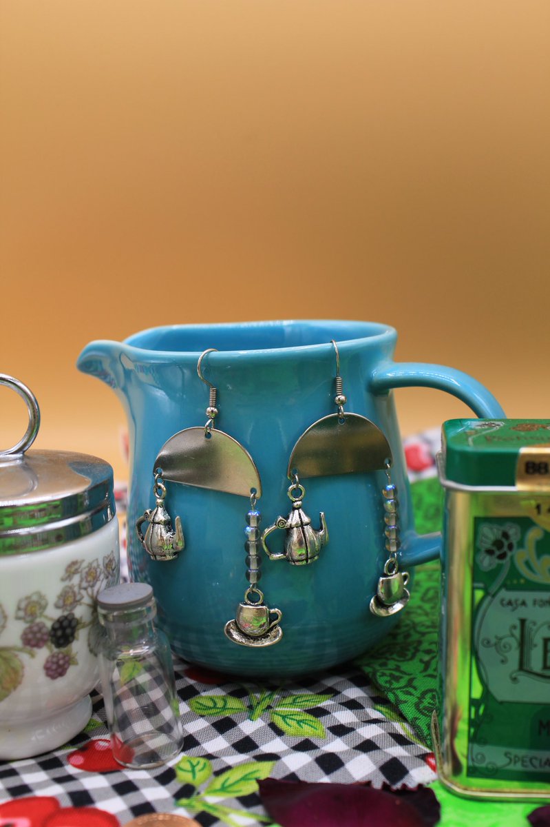 Lapis lazuli and silver spoon earrings, a cream ouija board with glittery blue goldstone, white howlite, jasmine, and subtle rodent bones, iridescent beaded tea set earrings, and colorful asymmetrical tea set earrings! http://www.stonerzines.com/the-borrowers-collection  #cottagecore  #handmade  #ghibli