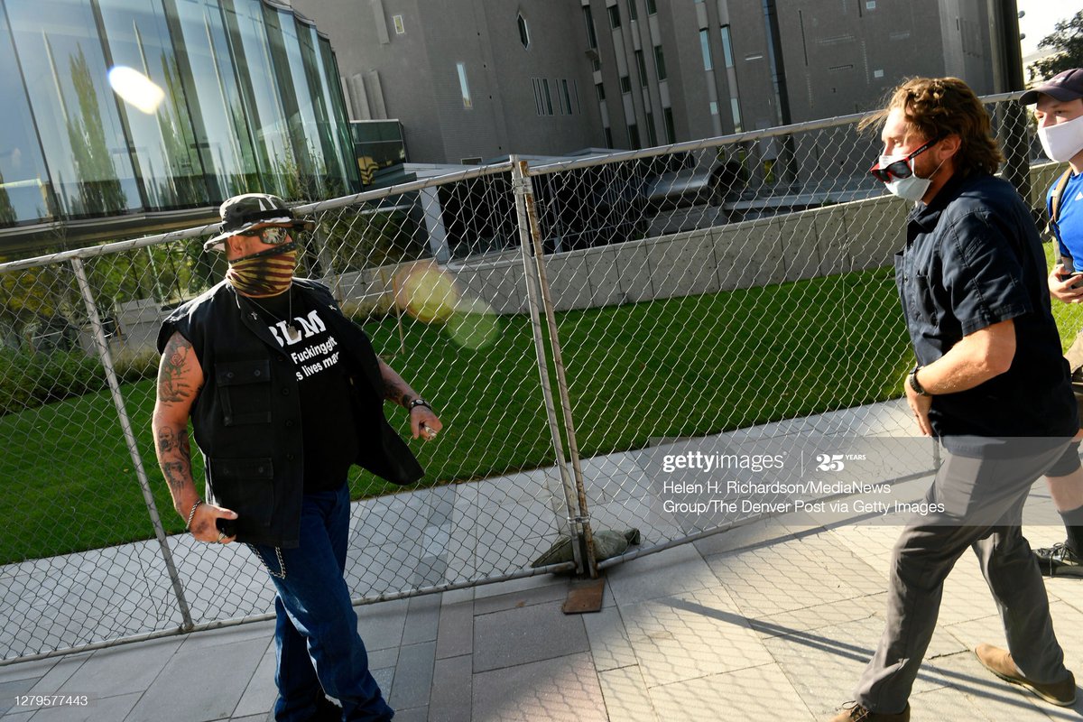 2) the two men back away from each other. Victim has can of mace at low, shooter is reaching for his gun (he is appendix carrying)