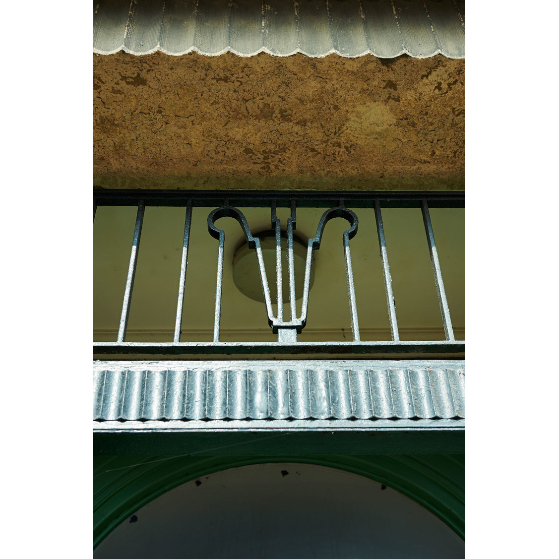 Art deco ironwork above the entrance features a semi circle motif also seen in the leaded glass work and arched doorway. The communal entrance has an original terrazzo floor with inlaid geometric detailing, this will look really special when fully refurbished. #meadowsgreen