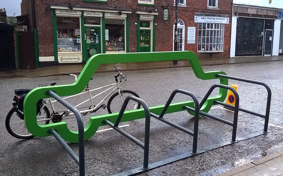 Our tandem 'posed for camera' at doomed cycle racks in Holbeach.  A few weeks before installation, we plus bike were blasted out of same bay by a motorist!
