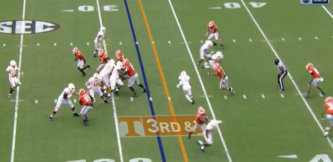 He gets the snap and looks to his first read, the wheel. But Georgia has the perfect call on. They're bringing a trap pressure. UGA has two rushers coming free, and a corner sitting in the flat on the wheel. JG has to go to his second read.