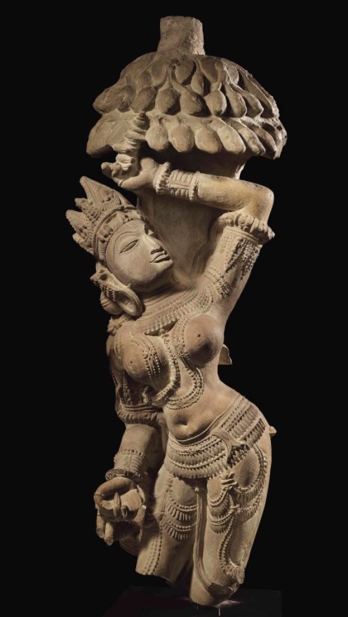 A buff sandstone figure of Salabhanjika 78 cm high India, Madhya Pradesh,11th century 'Standing beneath a fruit-laden mango tree...her voluptuous forms enhanced by bracelets, a festooned girdle & multiple beaded necklaces swaying with her movement...' christies.com/lotfinder/scul… 1/4