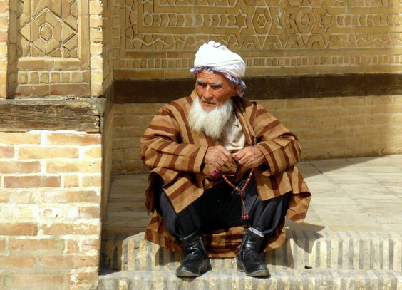 People of Bukhara: An old man in traditional clothes at the entrance of the Kalon Mosque.Frans Sellies.