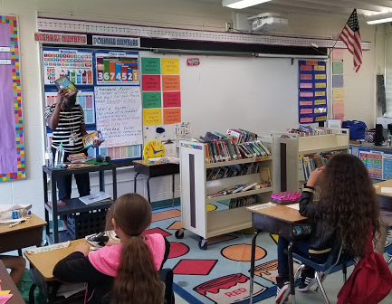 l_fogarty's tweet photo. Caught @DickensonReads heading down the hallway with her Mobile Library!  I don't know who was more excited, Ms. Brown or our @DickensonES 4th Graders! https://t.co/phnAYjZtA7
