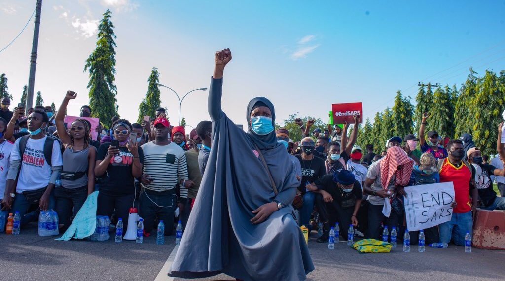 Wimbiz's tweet photo. This iconic picture of Nigerian Activist, Aisha Yesufu leading the charge at the ongoing #ENDSARS protest is both powerful and inspiring!⁣⁣ https://t.co/ZLUvqPjNST