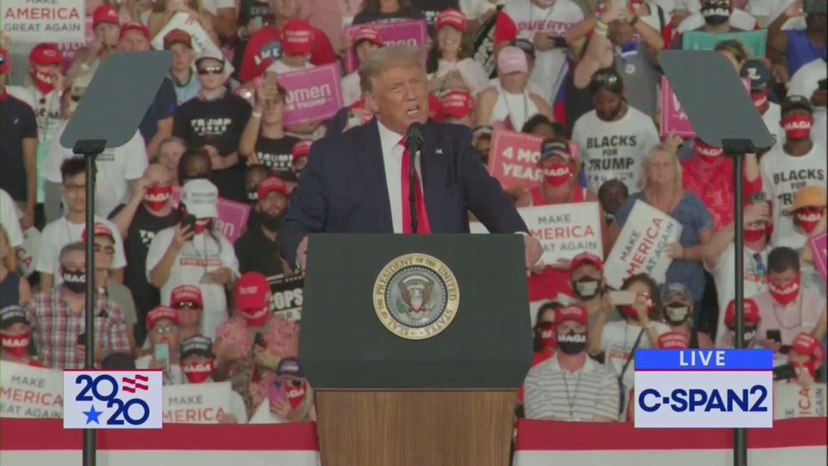 A lot of people without masks in the crowd behind Trump