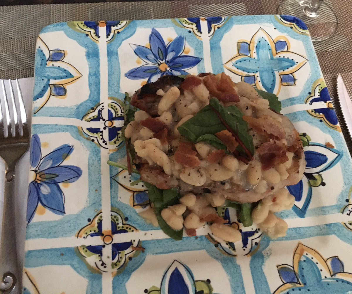 VanSavant's tweet photo. Heaven sent. Perfect Pork Chop, expertly grilled, and placed upon a lovely bed of greens. Topped with a cannelloni bean reduction. And bacon crumbles. Don’t forget those...lol... #pork #theotherwhitemeat #isthatracist #lol #getoveryourself #mondaynight #dinner https://t.co/Hevs2JlVlk