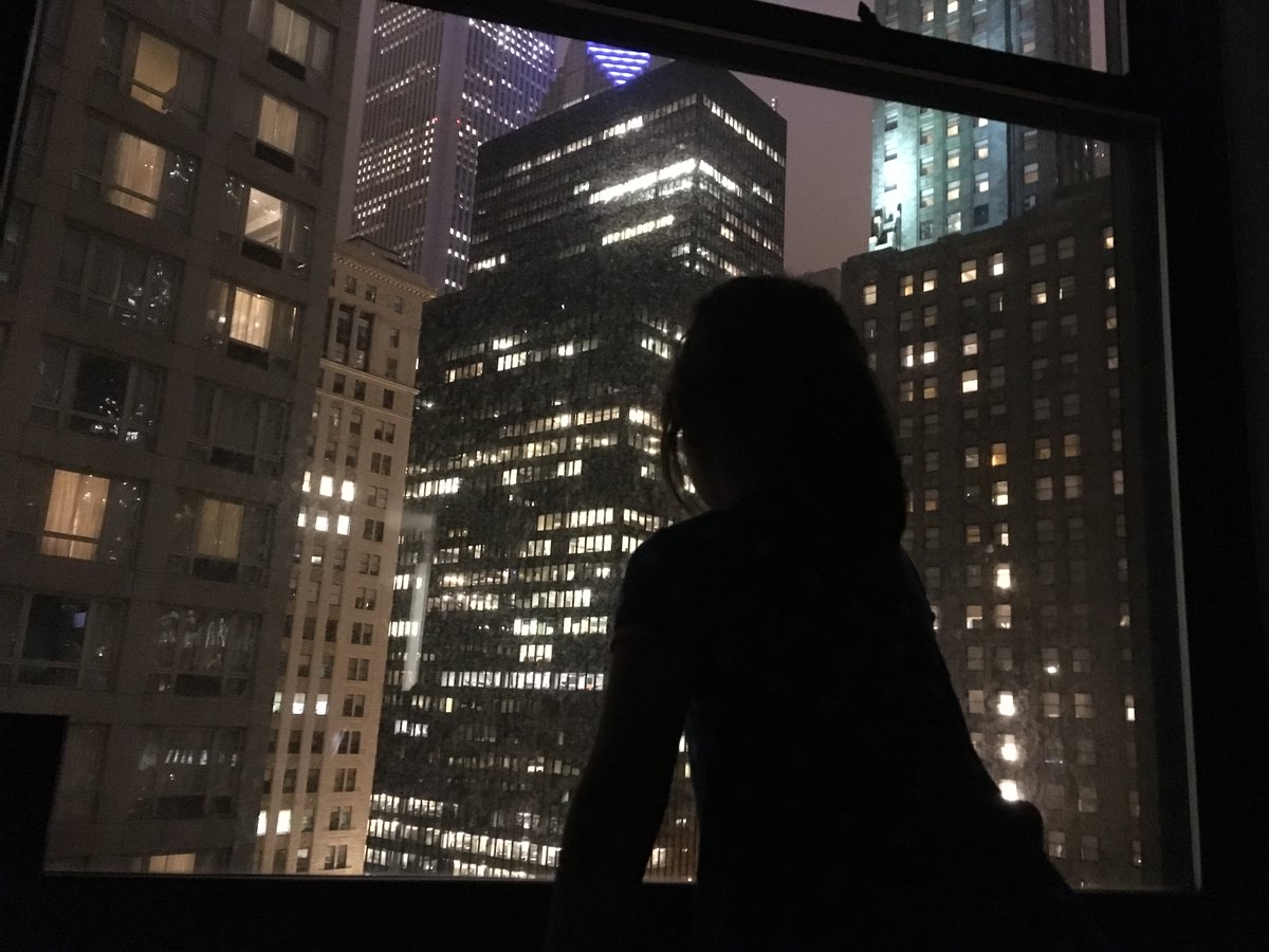 My daughter looking out a hotel window at the Chicago skyline.