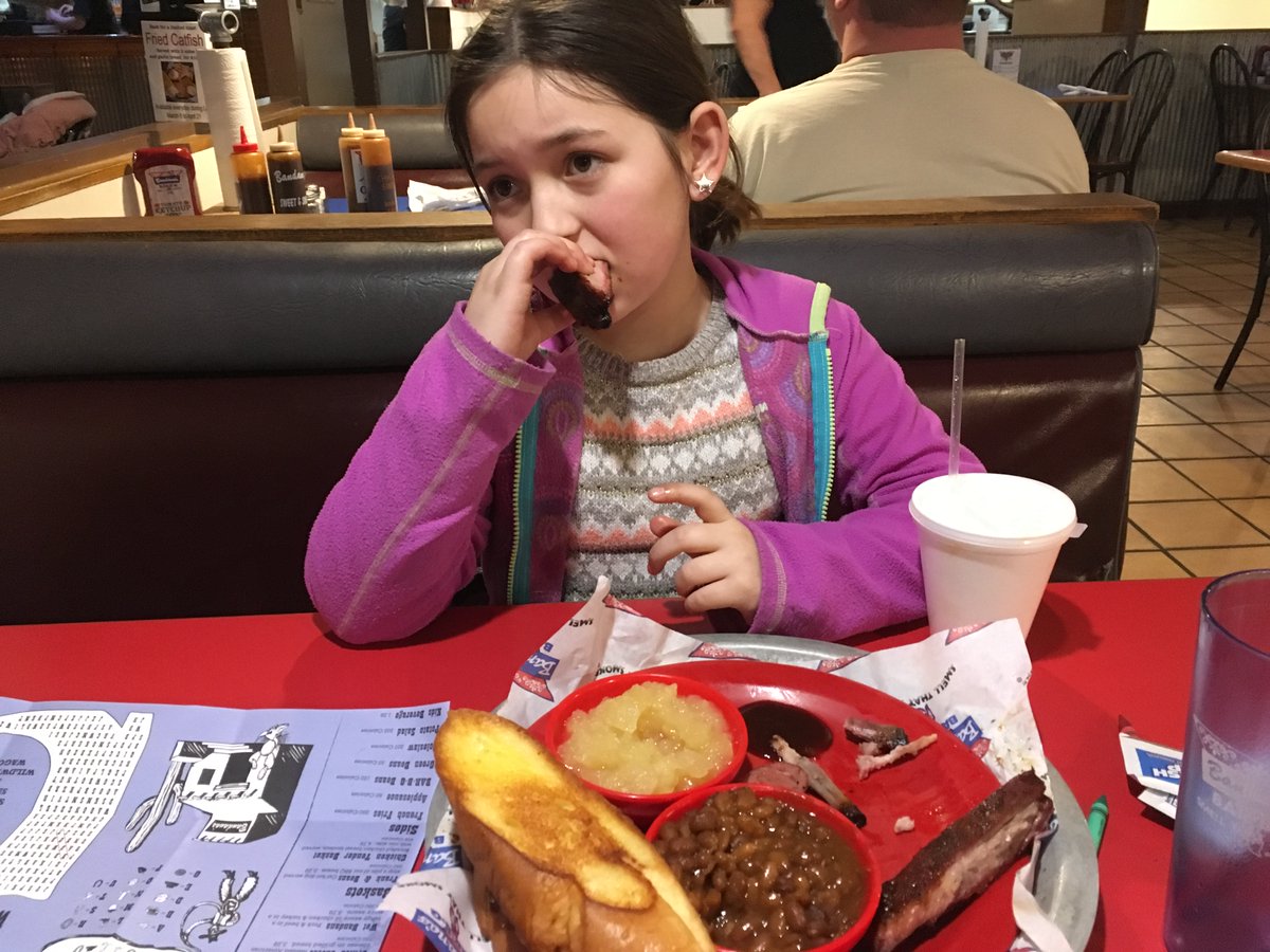 This is my daughter. She's so tired she can barely eat ribs. But I assure you, she has the strength to never rest. So long as there are ribs to eat.When we drove away from that restaurant, I found that she had rib bones in her pockets and was still chewing on them.