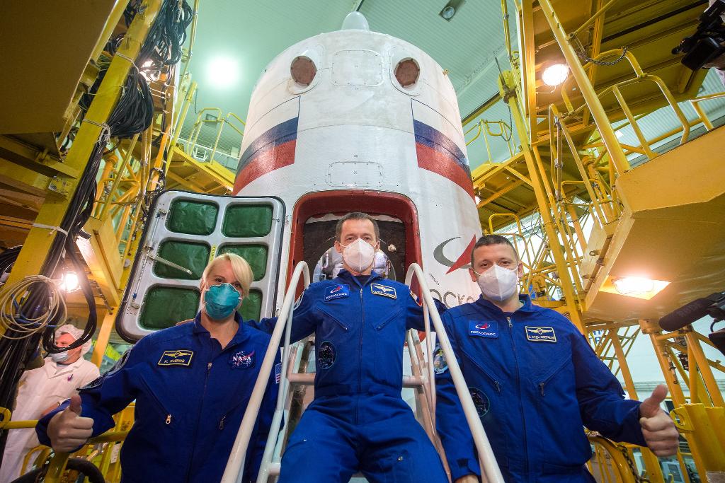 NASA astronaut Kate Rubins, left, and Russian cosmonauts Sergey Ryzhikov, center, and Sergey Kud-Sverchkov of Roscosmos, right, pose for a picture during the final Soyuz MS-17 spacecraft fit check.