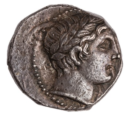 The Obverse of this coin shows the laureate bust of a young man, often treated as if it were an Apollo. Indeed, coins of the earlier Paeonian king Lycceius (ca. 359-340 BC) frequently featured Apollo and Zeus on the Obverse, so Patraos' coins reflect this tradition.