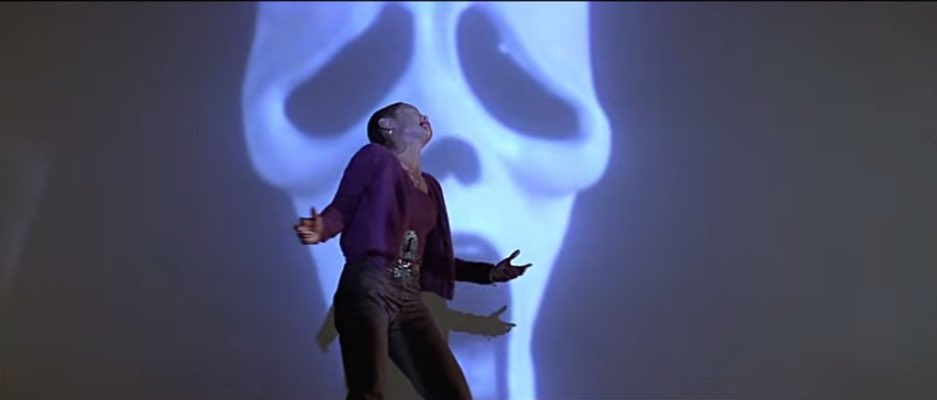 Wes uses Ghostface behind Maureen to figuratively show “the killer is behind you”. Yes. But, he cuts back to the audience and shows them masked as well. It’s a brilliant visual idea that the audience is also responsible for her murder. Lot of symbolism happening here.