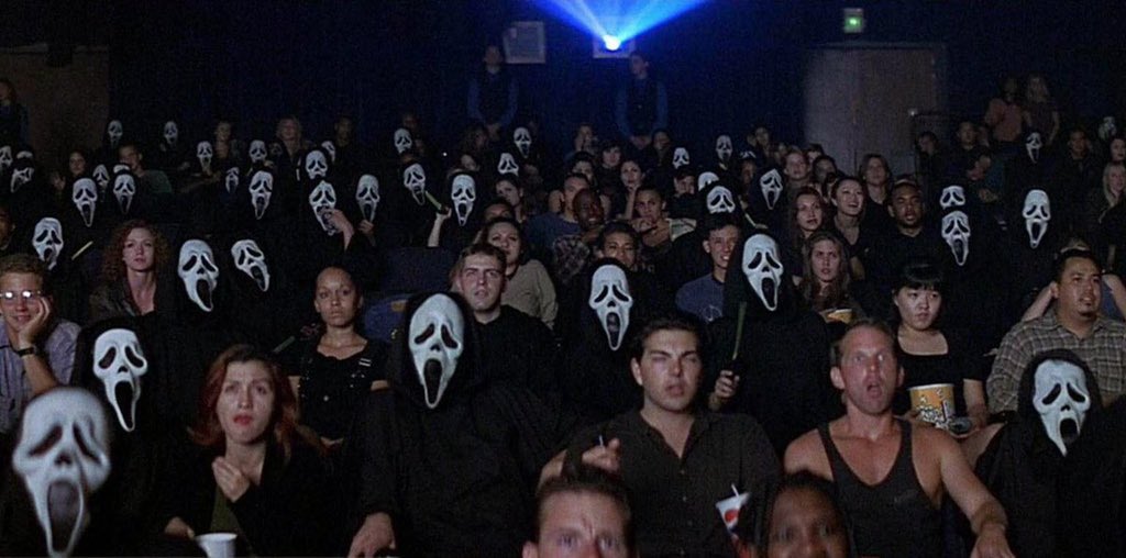 Wes uses Ghostface behind Maureen to figuratively show “the killer is behind you”. Yes. But, he cuts back to the audience and shows them masked as well. It’s a brilliant visual idea that the audience is also responsible for her murder. Lot of symbolism happening here.